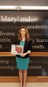 Megan Villano, HR Specialist, accepting the Community Partner Award on behalf of Precise Systems. 